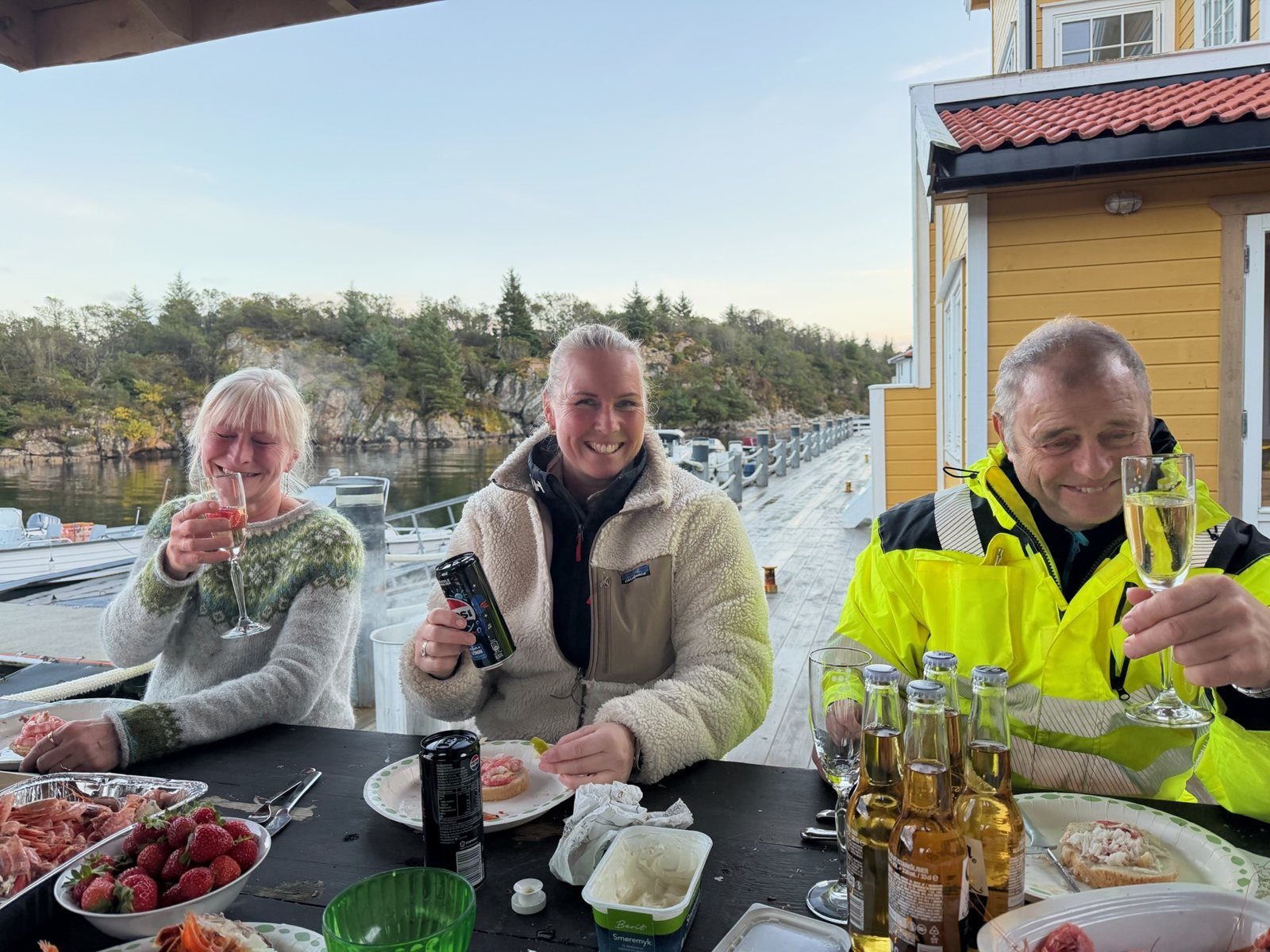 Guests toasting over a table of crab, prawns and oysters after the catch