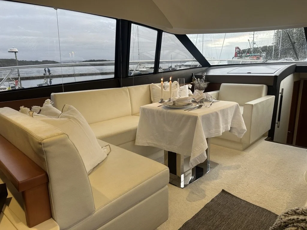 The saloon aboard Fjord Queen, table set with panoramic fjord views